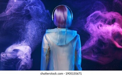 beautiful woman with purple hair in futuristic costume. blue and violet neon light. young girl in modern headphones listening music. swirling colorful smoke background.
