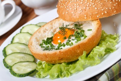 breakfast: sandwich with baked chicken eggs close-up on a plate. horizontal 