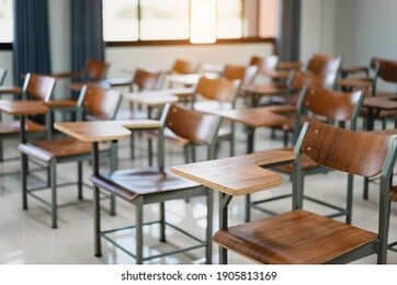 empty university classroom with many wooden chairs. wooden chairs well arranged in college classroom. empty classroom with vintage tone wooden chairs. back to school concept.