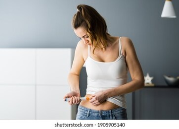 medicament self injection in belly using syringe with drug
