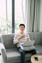 young man using laptop at home