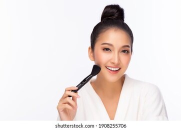 happy beauty asian woman hold makeup brush attractive beautiful girl get beauty makeup by using brush makeup beauty female get happy and smile face isolated on white background studio shot copy space