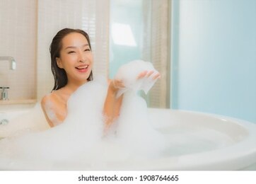 portrait beautiful young asian woman relax smile in bathtub at bathroom interior