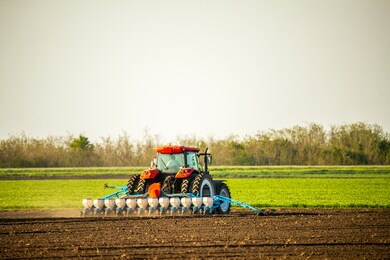 farmer seeding, sowing crops at field. sowing is the process of planting seeds in the ground as part of the early spring time agricultural activities.