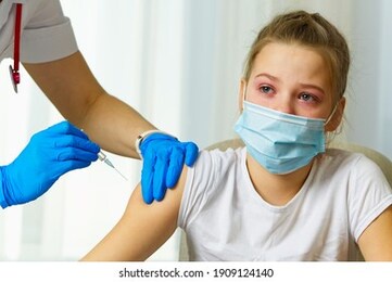 girl is crying afraid of the injection vaccination. fear of injections, the child with the nurse.