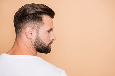 profile side photo of young bristle handsome man serious look empty space isolated over beige color background