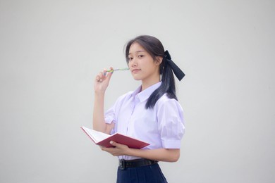 portrait of thai high school student uniform beautiful girl think