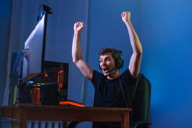 cybersport gamer feel excited while playing in online cyber sport play, won the game and cheer with hands gesture, screaming, feel glad and happy with his victory. computer dependence, games obsession