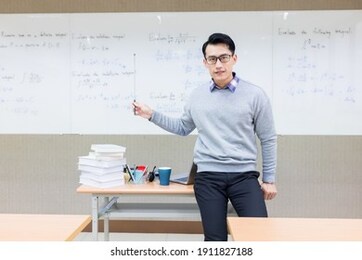 asian male professor teach calculus online through webcam in classroom