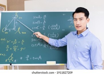 asian senior high school male teacher teach math online through webcam in classroom