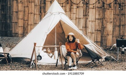 female traveller in front of camp tent, camping concept.