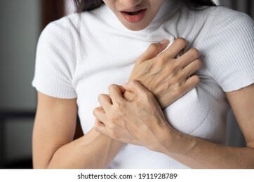 woman with sudden heart attack, sick woman suffering from acute heart attack, concept of emergency health care, asian young adult woman model