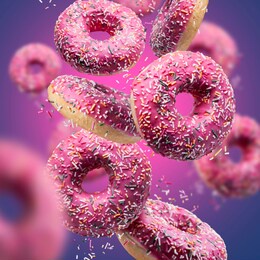 sweet appetizing donuts on a pink-blue background. donuts in motion.