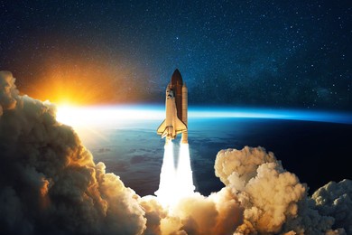 rocket lift off. space shuttle with smoke and blast takes off into space on a background of blue planet earth with amazing sunset. successful start of a space mission. travel to mars