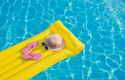beach summer holiday background. inflatable air mattress, flip flops and hat on swimming pool.