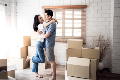 portrait images of asian couple , they hug each other and happy, because of the joy of moving to a new home together relocation, to people and family concept.