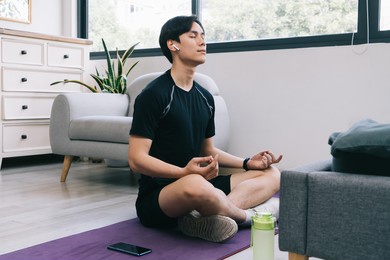young asian man exercising at home
