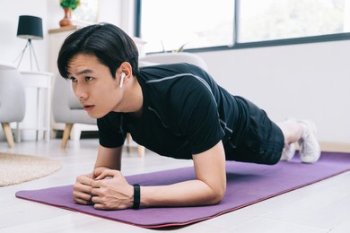young asian man exercising at home

