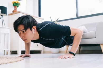 young asian man exercising at home
