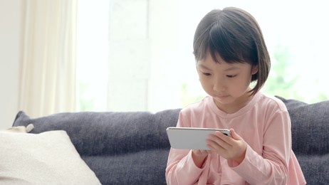 asian girl using smart phone on the sofa