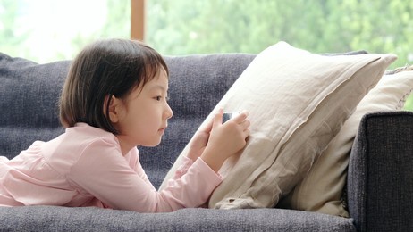 asian girl using smart phone on the sofa