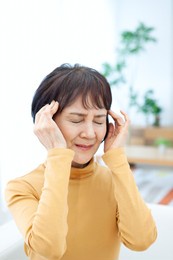 senior woman holding her head