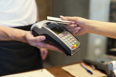 close up of customer paying by credit card 