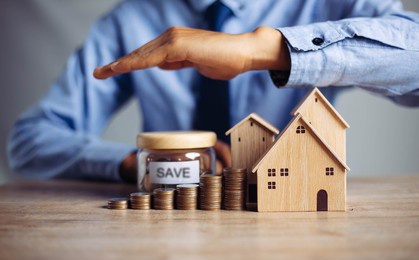 insurance house, and family health live concept. the insurance agent presents  the ้hands protection model that symbolize the coverage.