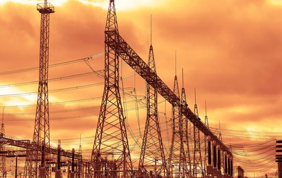 transformer : the equipment used to raise or lower voltage, high voltage power station. high voltage electric tower on  sky  background.