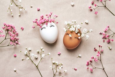white and black easter eggs with natural flowers wreath on linen background. zero waste easter concept. racial equality symbol