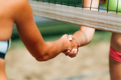beach volleyball girls shaking hands after the match 