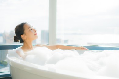 portrait beautiful young asian woman relax enjoy in bathtub in bathroom interior
