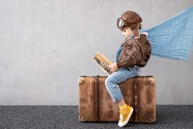 happy child playing outdoor. smiling kid dreaming about summer vacation and travel. imagination and freedom concept