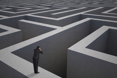 shouting businessman against difficult maze puzzle