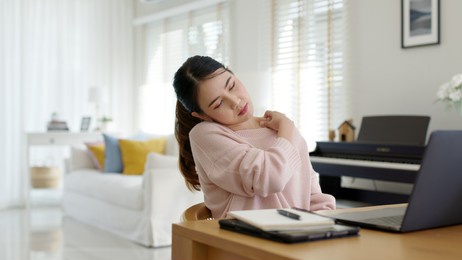 attractive beautiful young asia female feel tired overworked negative impact health life stretching for break time relax stress relief in concept problem work remotely from home or burnout syndrome.