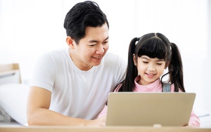 father and daughter learning education study online class. kid girl and dad using computer laptop at home