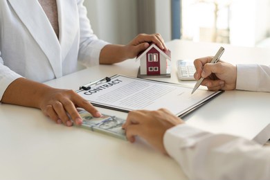 real estate brokerage agent hand over the house to the customer and sign the contract agreement home insurance concept making lease and buying a house