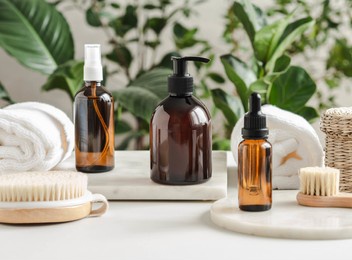 set of female skin care products. makeup products and skin cleansers on nature plant background. copy space. front view
