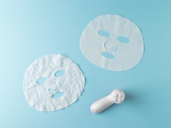 crumpled and smooth face masks and electric massager on a blue background. the concept of a rejuvenating effect on the skin.