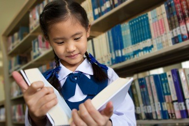 asian little student in library