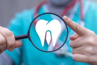 concept of dental care. dentist hold magnifier with tooth icon. teeth clean and oral health.