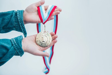 hand holding gold medal. children competition. sport success and win concept.