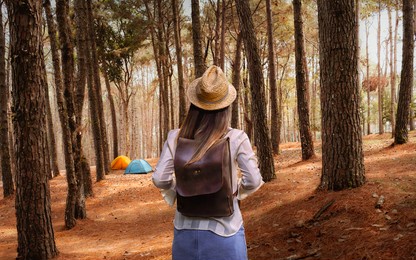 lifestyle young traveler woman with backpack in pine forest, attraction nature outdoor adventure travel phitsanulok thailand, tourist girl on holiday vacation trip, tourism beautiful destinations asia