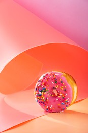 donuts on pink and caramel swirled background with copy space