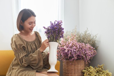 beautiful asian women spend their vacations arranging flowers in vases to decorate their homes.