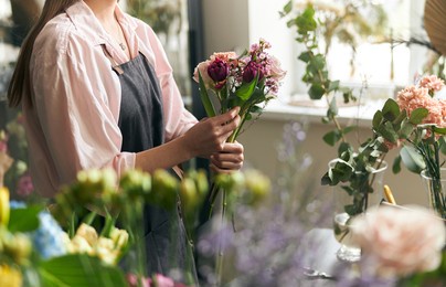 gardener s in the flower shop make bouquet for a holiday. lifestyle flower shop. beautiful flower composition. detail. close up