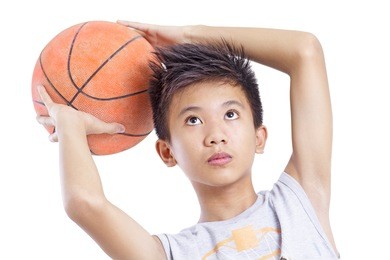 young basketball player concentrating in shooting the ball. isolated in white background.