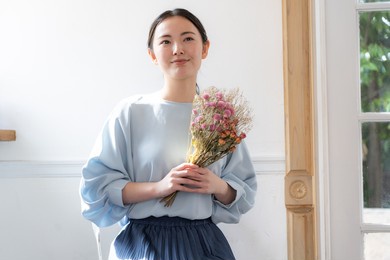 portrait of a japanese woman spending time in a fashionable room