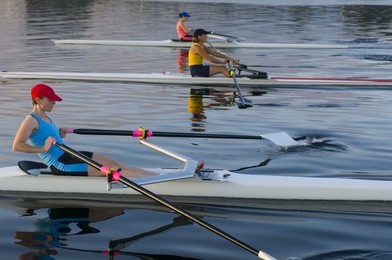 three rowers competing.