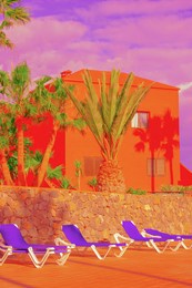 fashion tropical minimal location. orange hotel and palm. blue summer sky. canary islands.  travel aesthetics wallpaper